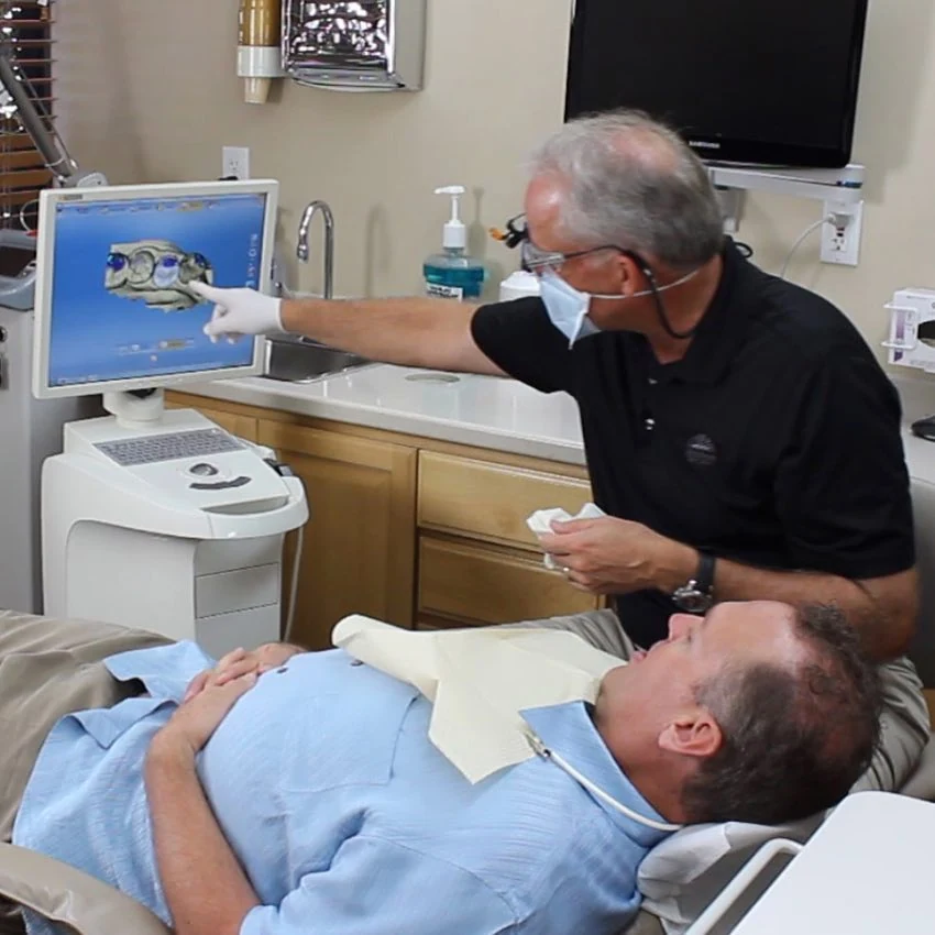Dr. Sandstrom showing a patient their scan on the operatory screen